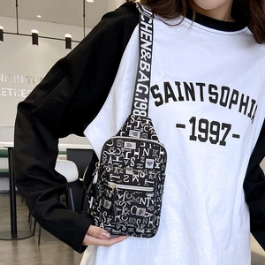 Detail of crossbody chest bag with monochrome letter print and branded shoulder strap