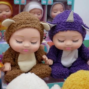 Close-up of 8-inch sleeping dolls in brown bear and purple unicorn plush outfits