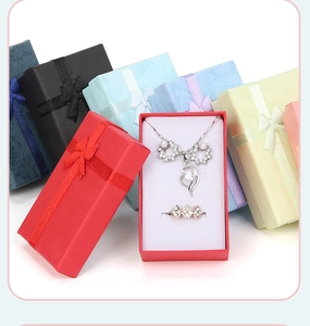Close-up of assorted jewelry gift boxes with bow ribbons and white flocking lining inserts