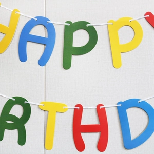 Close-up of colorful daisy happy birthday banner in vibrant macaron shades