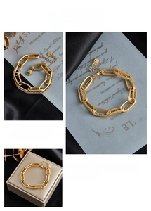 Detail view of gold double-layered chain bracelet with lobster clasp and adjustable link
