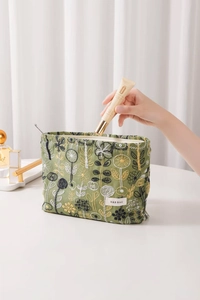 Detail showing the inner capacity of the green floral embroidered linen cosmetic bag