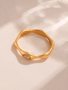 Macro view of 18k gold plated stainless steel wave ring with light yellow gemstone
