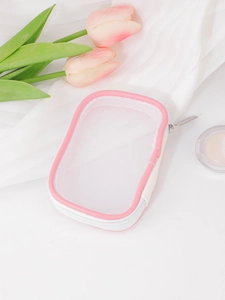 Close-up of pink mesh makeup bag with silver zipper and fine polyester mesh texture