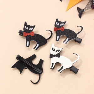 Detail view of cat Halloween hair clips with glitter bows and metal duckbill clip