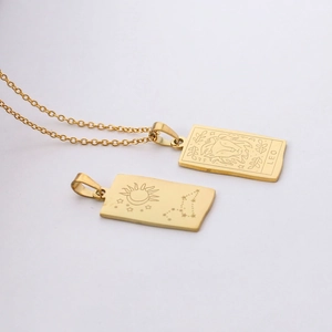 Detail of gold Leo zodiac rectangle pendant necklace with engraved lion head and stars