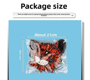 Detail view of plush tiger headband set in packaging with 21cm x 18cm dimensions