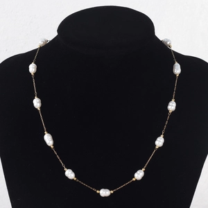 Baroque pearl necklace with gold-plated titanium steel chain on a black mannequin