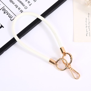 Detail of white PU leather keychain wristlet with premium gold metal spring ring buckle