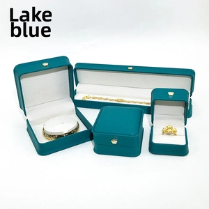 Lake blue PU leather jewelry boxes with gold crown detail and plush white interior