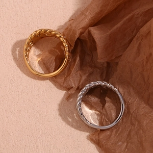 Close-up of twisted rope texture rings in gold and silver finish with diamond accents
