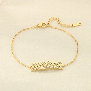 Detailed macro view of the Mama gold bracelet with zircon inlay and S-STEEL stamp