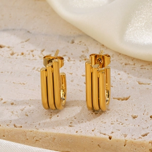 Modern gold-plated stainless steel triple-layer U-shaped earrings on beige stone