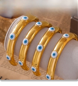 Macro shot of gold-plated evil eye bangles with PVD electroplating detail
