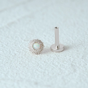 Macro view of s925 silver flat back labret stud with opal inlay in a sunburst design