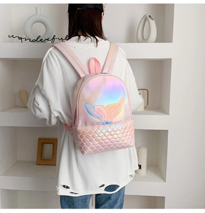 Detail of mermaid tail embroidery and iridescent scale texture on pink backpack