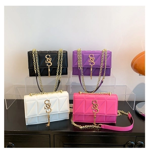 Detailed group view of V-quilted chain bags with gold logo and tassel in four colors