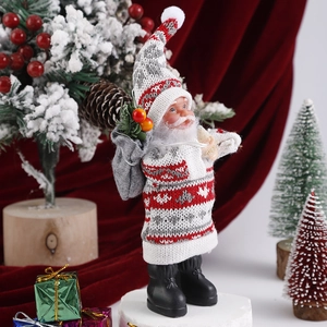 Close-up of plush Santa Claus figure with knit hat and velvet background details