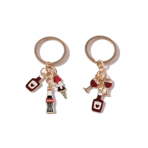 Golden keychain with miniature red wine glass, cola bottle, and ice cream charms
