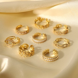 Set of 18K gold plated zircon rings on gold satin background showing luxury geometric designs
