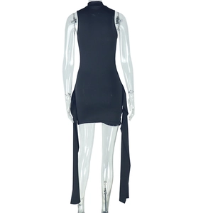 Detail of the back of a slim-fit black sleeveless mini dress with long decorative ribbons