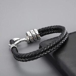 Detail of black double-braided leather bracelet with vintage silver-tone metal clasp