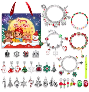 Flat lay of Christmas advent calendar jewelry kit with bracelets and festive charms