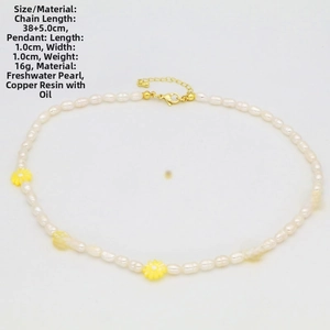 Detailed close-up of natural pearl necklace with five small yellow daisy flower pendants