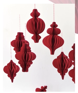 Detail of dark red honeycomb paper lanterns hanging for festive Christmas party decoration