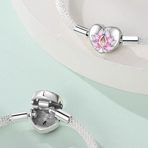 Silver charm bracelet featuring an opening heart locket with pink lotus and S925 hallmark