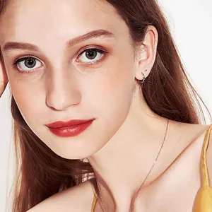 Minimalist silver titanium steel hoop earrings and chain necklace worn by a model
