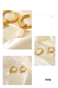 Detail view of 18K gold plated hoop earrings with white oval pearl pendants