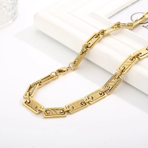 Detail shot of golden geometric rectangular link chain necklace with lobster clasp