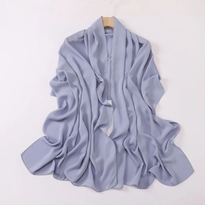 Close-up of a light blue satin headscarf hanging on a wooden hanger with smooth texture