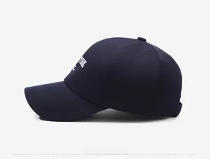 Detailed side view of navy blue baseball cap with white New York letter embroidery