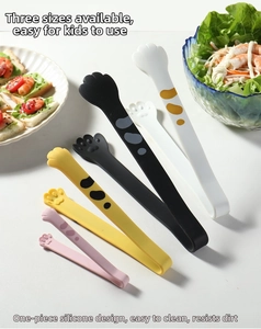 Detail of cat paw silicone tongs in black, white, yellow, and pink with various sizes