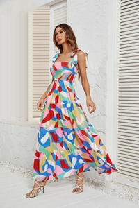 Detail of summer dress featuring multi-color abstract print and tie-up shoulder straps