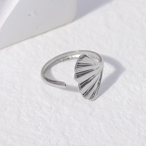 Detailed close-up of adjustable stainless steel ring with elegant ginkgo leaf design