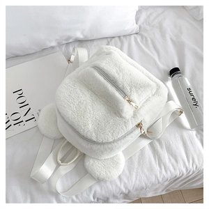 Detail view of white plush backpack with cute round ears and soft fabric texture