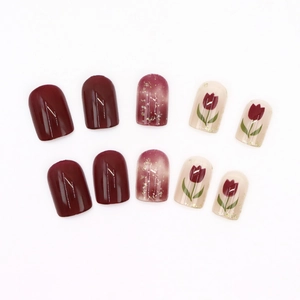 Short square press-on nails with burgundy tulip designs and gold glitter accents