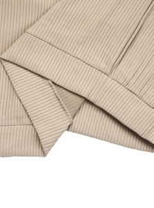 Macro view of khaki ribbed knit texture and stitching details on the casual long sleeve top