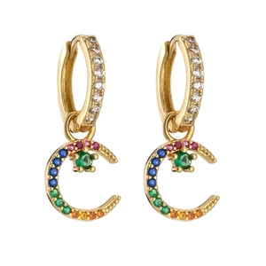 Detailed close-up of gold moon earring with rainbow crystals and star-set emerald gem