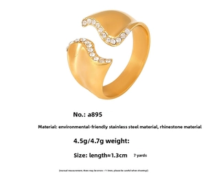 Detail view of 18k gold plated irregular wave ring with white rhinestone inlay specs
