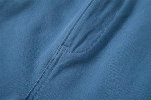 Macro shot of blue cotton fabric texture with durable double-stitched seam details