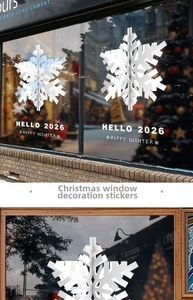 Close-up of white 3D snowflake window stickers with Happy Winter and Hello 2026 text