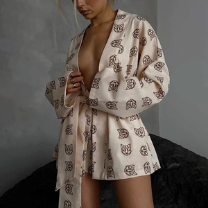 Detail of printed kimono lounge set showing cotton-linen texture and waist-tie closure
