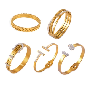 Collection of geometric gold-plated titanium steel bangles with sparkling diamond accents