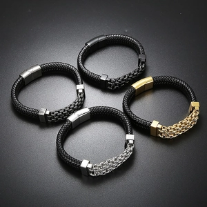 Top view of four punk style braided leather bracelets with magnetic clasps and metal chains