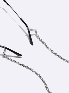 Silver metal eyewear chain with silicone loops shown on black glasses frames