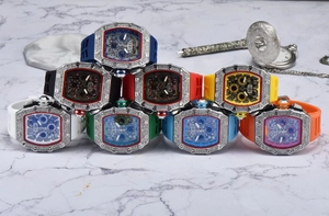 Close-up of diamond-set tonneau watches with colorful silicone straps and skeleton dials